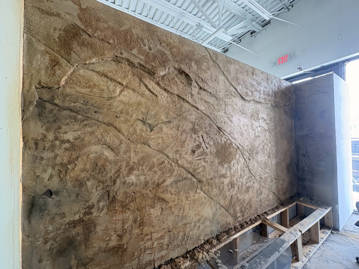 Large rough natural rock textured wall in progress